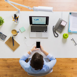 businesswoman with laptop and smartphone at office