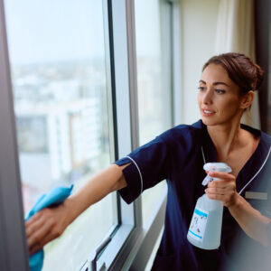 Young cleaning lady working in a hotel. Copy space.